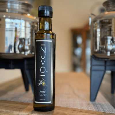Bottle of Picual extra virgin olive oil on tasting table